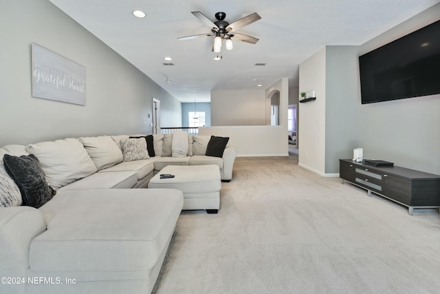 living room featuring light carpet and ceiling fan