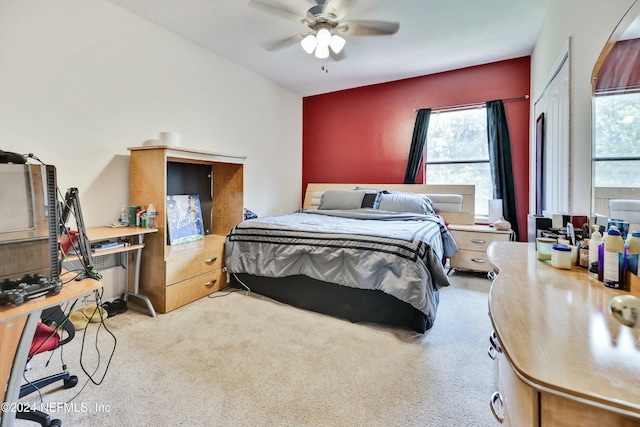 bedroom with ceiling fan and light colored carpet