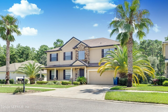 view of front facade featuring a garage and a front lawn