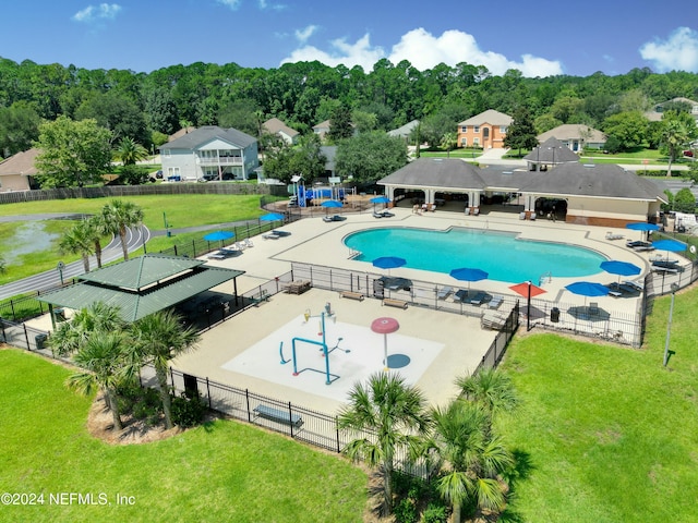 view of pool with a lawn and a patio area