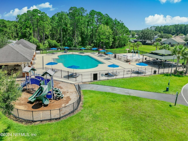 view of pool featuring a playground and a yard