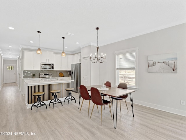 dining space with a chandelier, light wood-type flooring, and ornamental molding