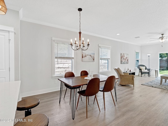 dining room featuring a textured ceiling, ceiling fan with notable chandelier, hardwood / wood-style flooring, and ornamental molding