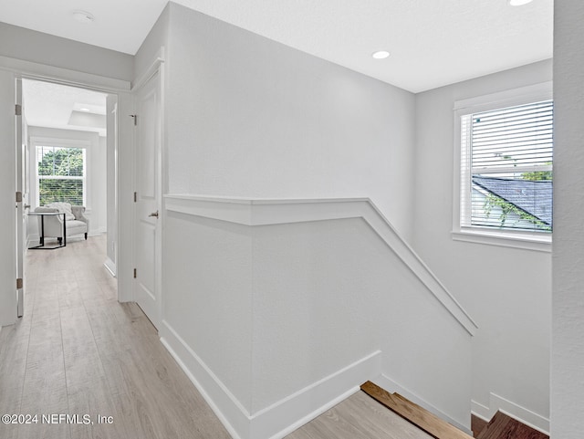 corridor with light hardwood / wood-style floors