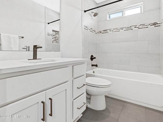 full bathroom with tile patterned flooring, vanity, tiled shower / bath combo, and toilet