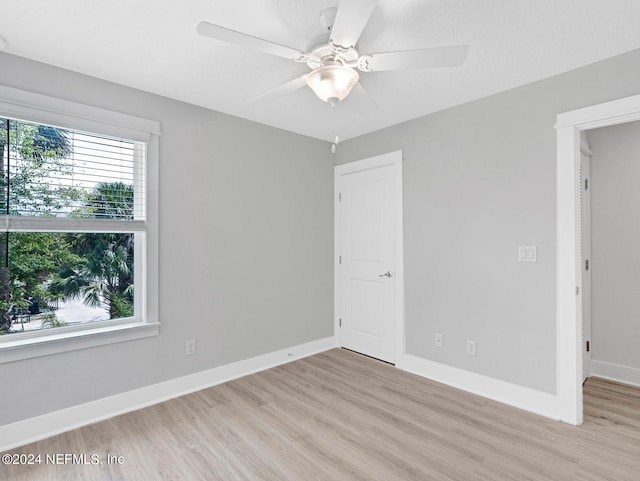 spare room with light hardwood / wood-style flooring and ceiling fan