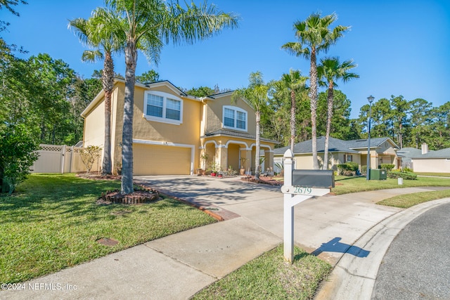 view of front of property featuring a garage and a front yard