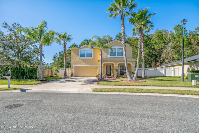 view of front of house featuring a garage and a front yard