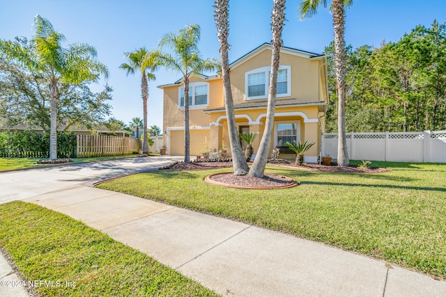 view of front of property with a garage and a front lawn