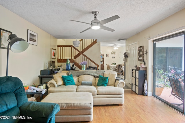 2975 SW Sunset Trace Cir Unit 2975, Palm City, FL 34990 - living room featuring ceiling fan, light wood-type flooring, and a textured ceiling