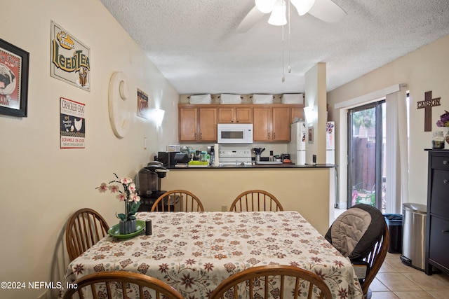2975 SW Sunset Trace Cir Unit 2975, Palm City, FL 34990 - dining space featuring ceiling fan, light tile patterned flooring, and a textured ceiling