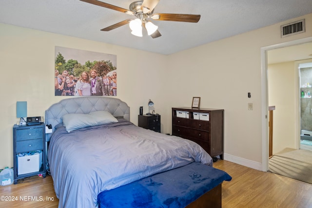 2975 SW Sunset Trace Cir Unit 2975, Palm City, FL 34990 - bedroom featuring ceiling fan, light hardwood / wood-style floors, and a textured ceiling