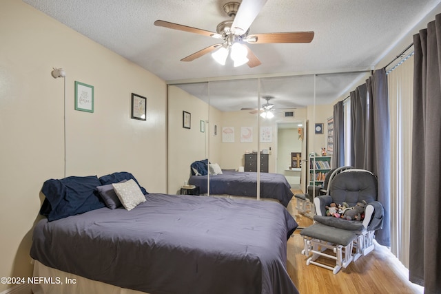 2975 SW Sunset Trace Cir Unit 2975, Palm City, FL 34990 - bedroom featuring hardwood / wood-style floors, a textured ceiling, a closet, and ceiling fan