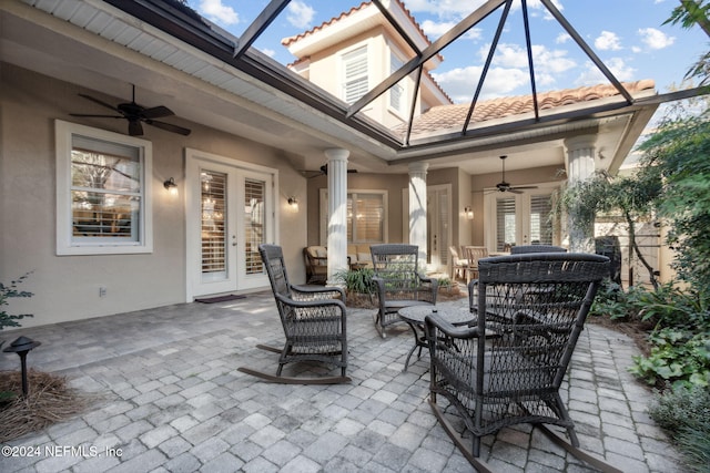 view of patio / terrace with glass enclosure, ceiling fan, and french doors