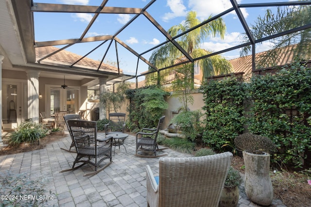 view of patio / terrace featuring glass enclosure and ceiling fan