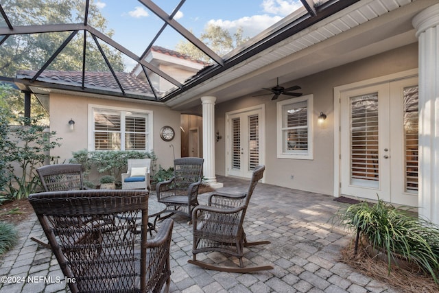 view of patio / terrace with french doors, ceiling fan, and a lanai