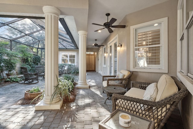 view of patio with ceiling fan and a lanai