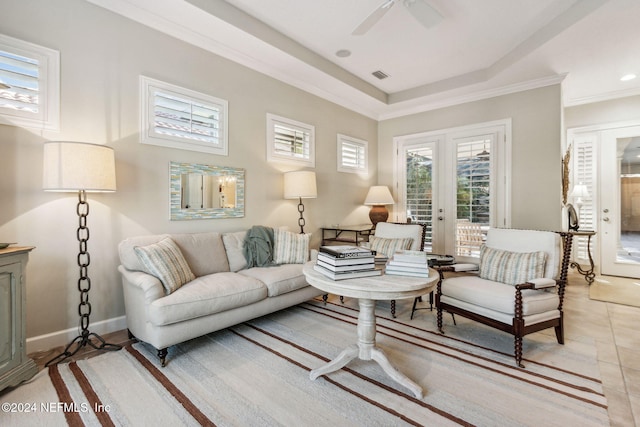 tiled living room with ceiling fan and crown molding