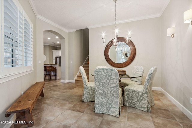 dining space featuring crown molding and a chandelier