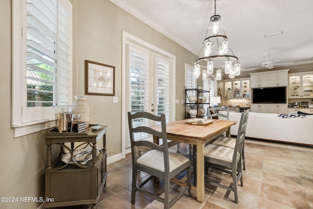 dining area with ceiling fan, a healthy amount of sunlight, light tile patterned flooring, and crown molding