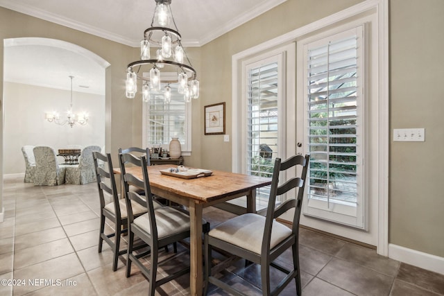 dining room with a chandelier, french doors, tile patterned floors, and crown molding