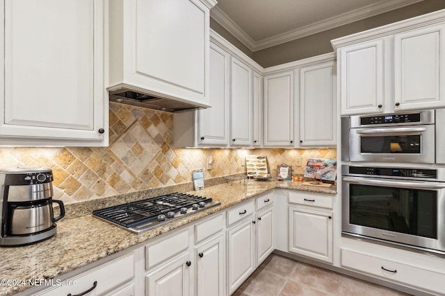 kitchen featuring appliances with stainless steel finishes, tasteful backsplash, and white cabinetry