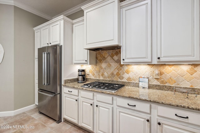 kitchen with white cabinetry, stainless steel appliances, decorative backsplash, light tile patterned flooring, and ornamental molding