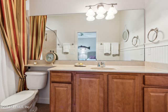 bathroom featuring vanity, ceiling fan, toilet, and curtained shower