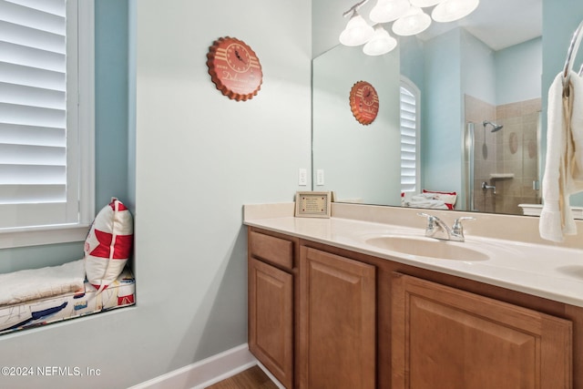 bathroom with vanity and tiled shower