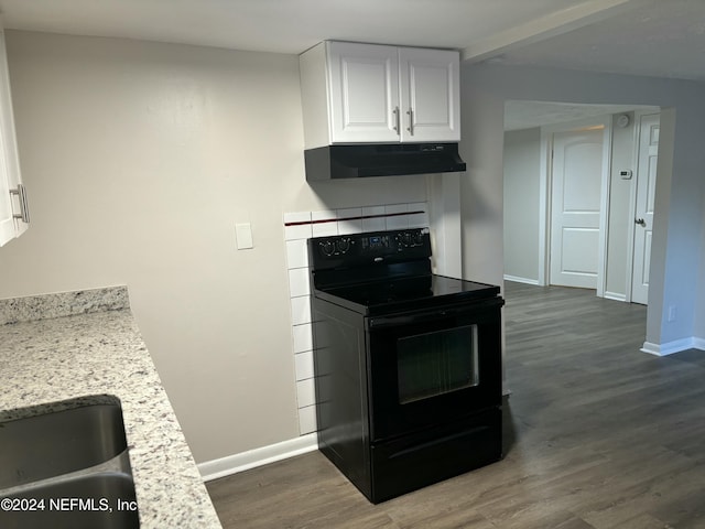 kitchen featuring black / electric stove, light stone countertops, dark hardwood / wood-style floors, and white cabinets