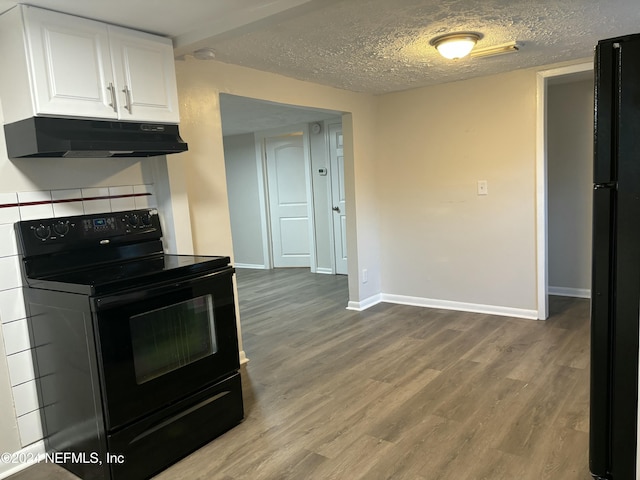 kitchen featuring white cabinetry, wood-type flooring, a textured ceiling, and black appliances