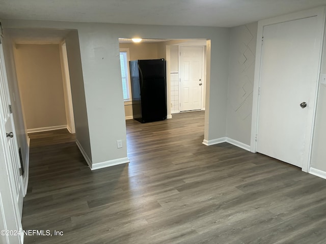 empty room with dark hardwood / wood-style flooring