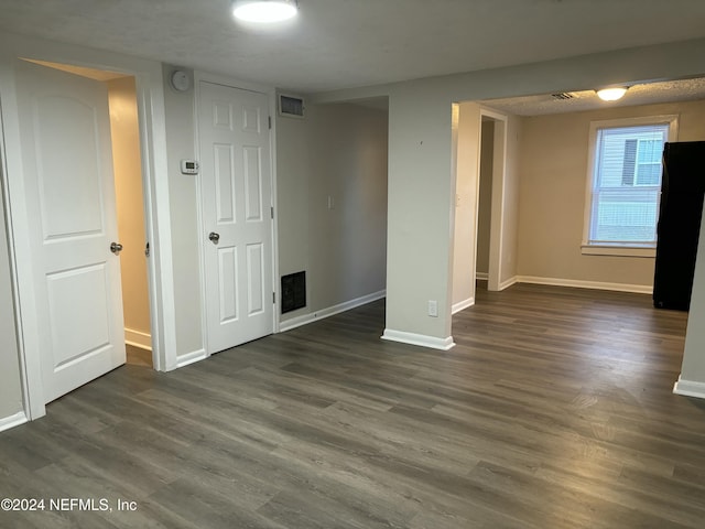 unfurnished room featuring dark hardwood / wood-style floors