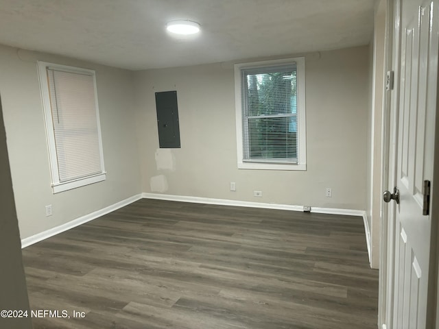 unfurnished room featuring dark hardwood / wood-style flooring and electric panel