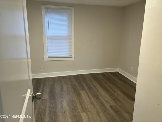 empty room with dark hardwood / wood-style floors