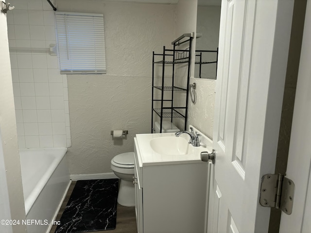 full bathroom with vanity, tiled shower / bath combo, and toilet