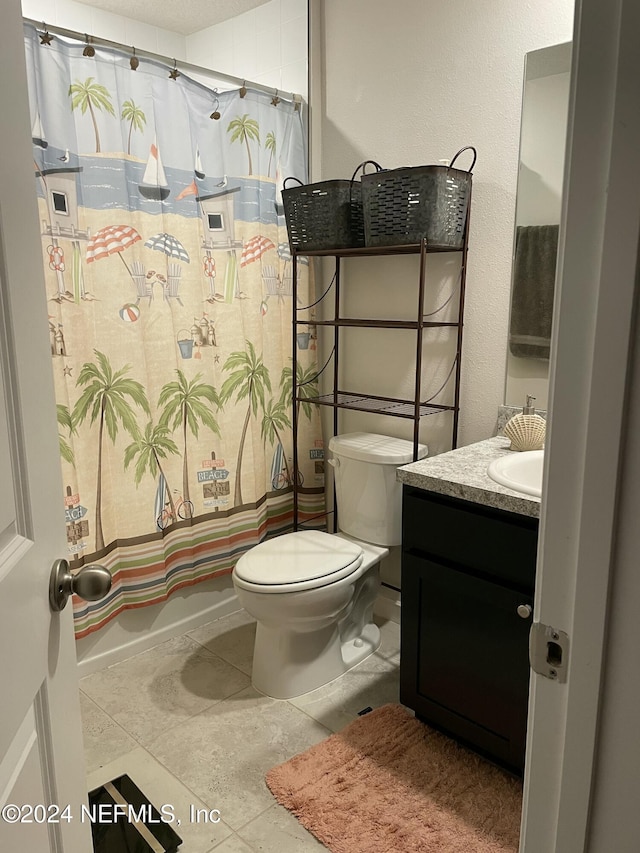 full bathroom with tile patterned flooring, vanity, shower / bath combo, and toilet