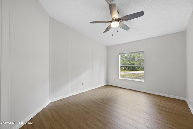 unfurnished room with wood-type flooring, a textured ceiling, and ceiling fan