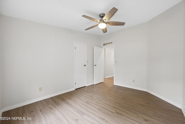 empty room featuring ceiling fan and light wood-type flooring