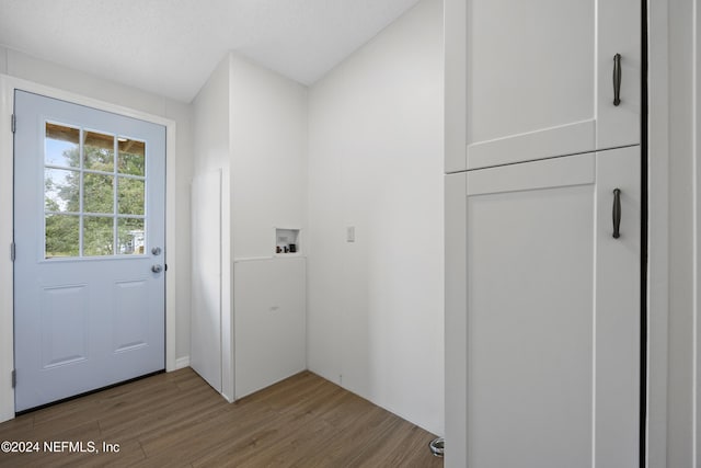 doorway to outside with hardwood / wood-style floors and a textured ceiling