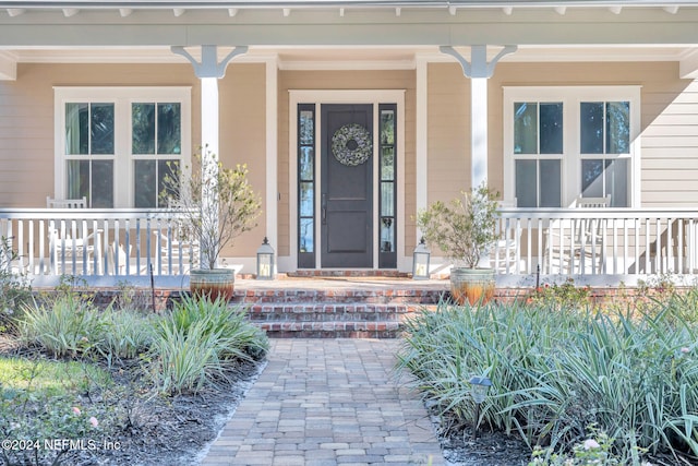 doorway to property featuring covered porch