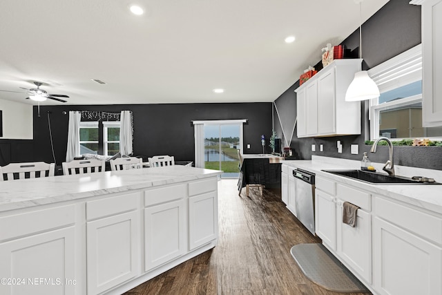 kitchen featuring plenty of natural light, dishwasher, sink, and decorative light fixtures