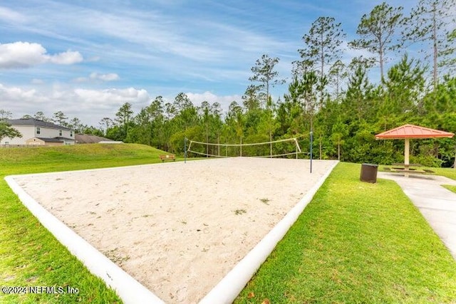 surrounding community featuring volleyball court and a lawn