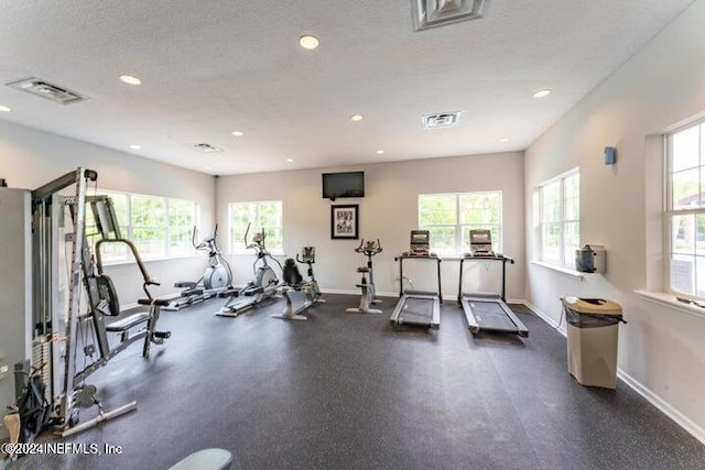 gym featuring a textured ceiling