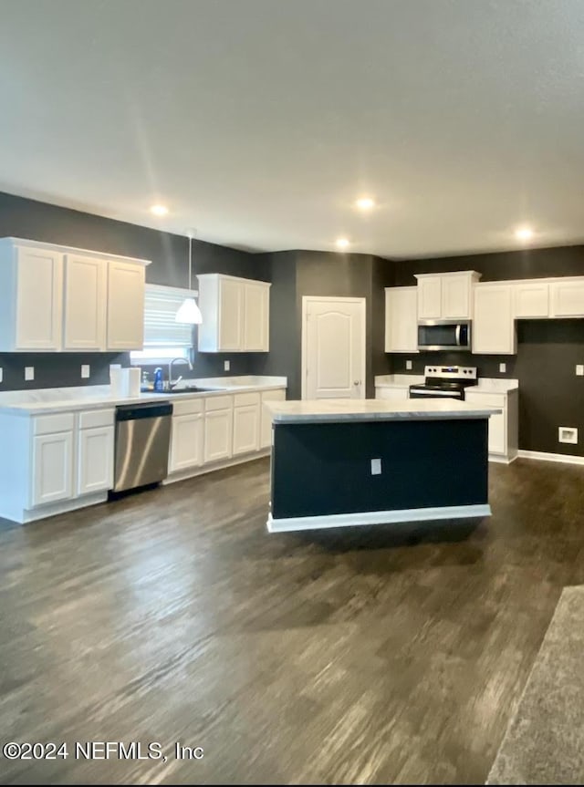 kitchen with white cabinetry, decorative light fixtures, and appliances with stainless steel finishes