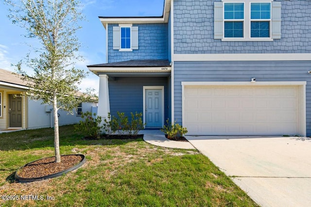 view of front of property with a garage and a front yard