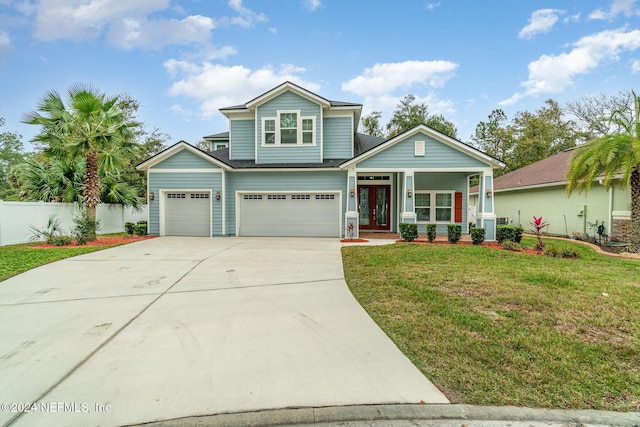 craftsman inspired home featuring french doors, a front lawn, covered porch, and a garage