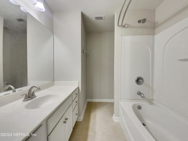 bathroom with a textured ceiling, vanity, tile patterned floors, and tub / shower combination