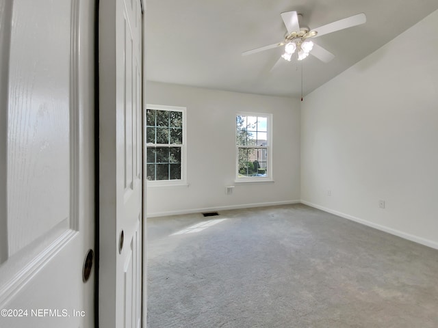 carpeted spare room featuring ceiling fan