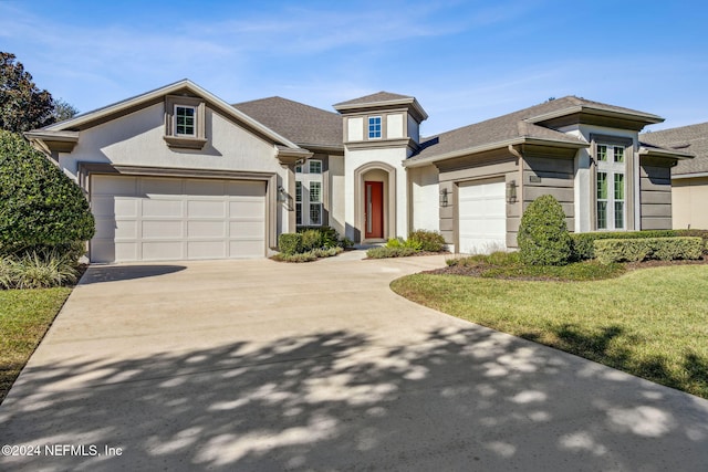 view of front facade with a garage and a front yard